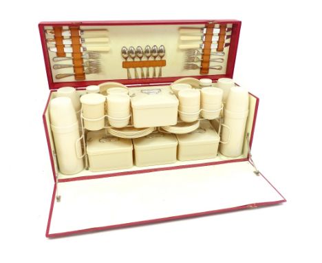 A mid 20th century fitted picnic hamper for six people, to include cutlery, plates, storage jars etc, in a associated fall fr