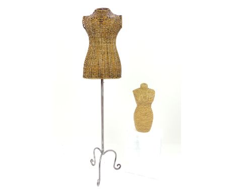 A vintage full size cane manequin of female torso, raised on a brushed steal adjustable tripod base, terminating in scroll fe