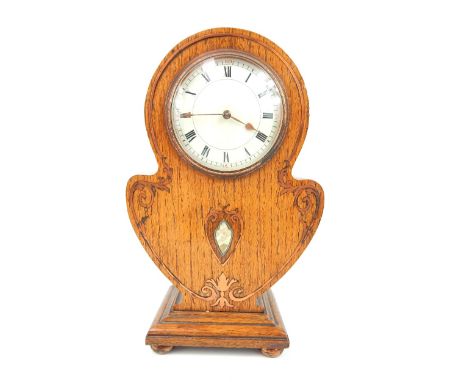 An art nouveau copper and mother of pearl inlaid oak mantle clock, with spring driven movement which has white dial and roman