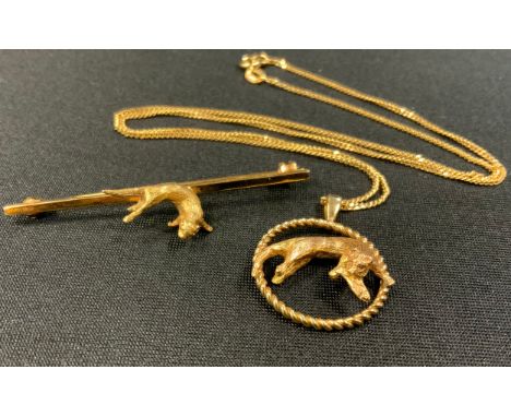 A 9ct gold pendant necklace, as a Swimming Otter with Fish, suspended from a fine curb link chain, 44cm long, 6.7g;  a simila