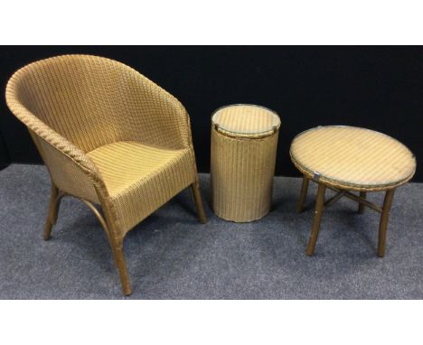 A Lloyd Loom lusty gold coloured chair, conforming circular side table &amp; linen basket (3) 