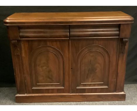 A Victorian mahogany chiffonier, rounded rectangular top above a pair of moulded drawers and a pair of arched panel cupboard 