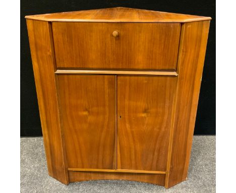 A retro mid-20th century Nathan corner bureau, fall front enclosing pigeon holes, above a pair of doors enclosing a shelf, 99