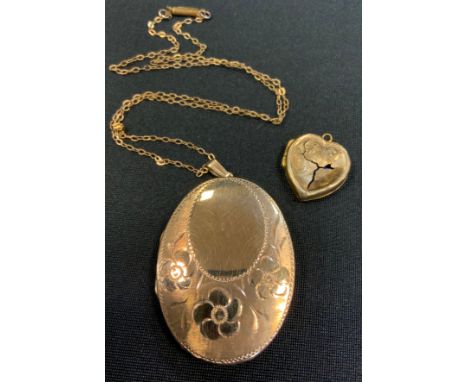 A large 9ct gold oval locket, floral front, plain rear, stamped 375, 13.3g gross, suspended from a gold plated chain, 9ct gol