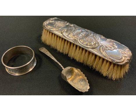 Silver - a Victorian silver sugar scoop, Birmingham 1876;  napkin ring, silver backed brush, 94g gross 