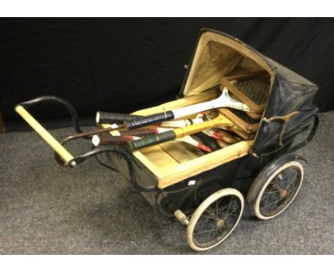 A Victorian style Sidney Ross wrought iron pram; a silver mounted walking stick; tennis rackets.(7) 