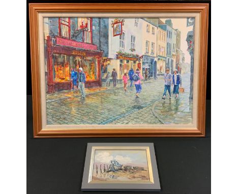 K. Spencer,The High Street, after a Shower,signed, oil on canvas, 39cm x 69cm;  another, boats at low tide, oil on board, 15.