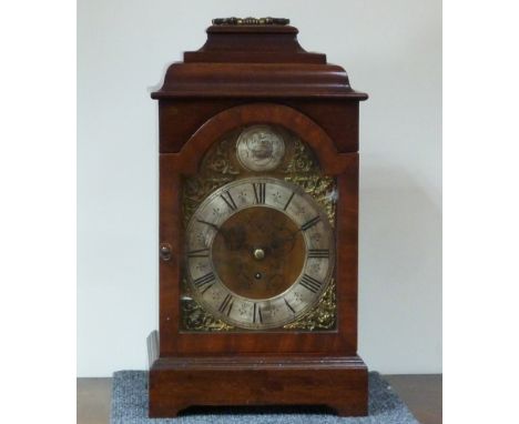 An Edwardian mahogany bracket clock with bell top, the silvered dial signed R.Rowley London and with pierced brass spandrels,