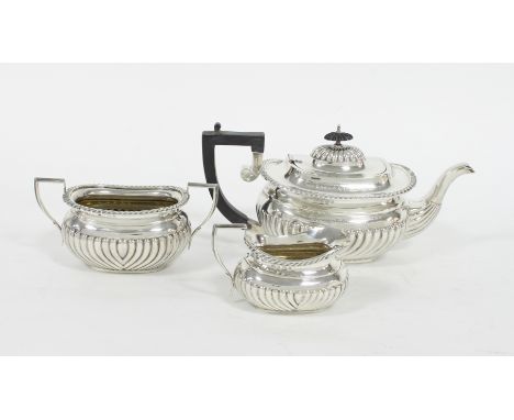 A three-piece silver tea set, CH, Birmingham 1903, of oblong half ribbed form with gadrooned borders, inscription to the teap