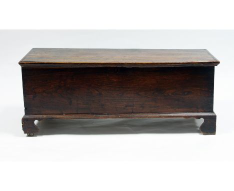 An oak chest with hinged cover, on bracket feet, 123cm wide