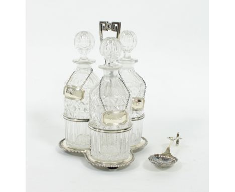 A silver plated decanter stand, TB&S, of trefoil shape with stylised handle, the three cut glass decanters with modern silver