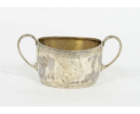 A twin-handled silver sugar basin, H.S, Sheffield 1886, with bands of scroll decoration and a vacant wreath cartouche to each