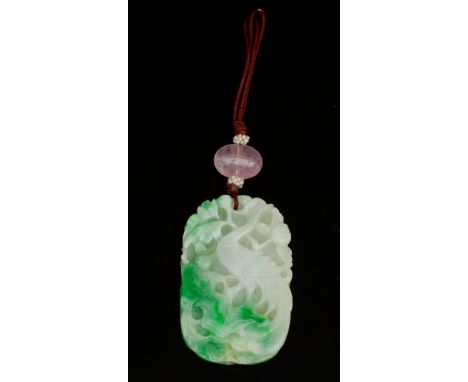 A jade plaque pendant, the rectangular shaped plaque carved with birds of paradise to each side, on a brown silk cord decorat