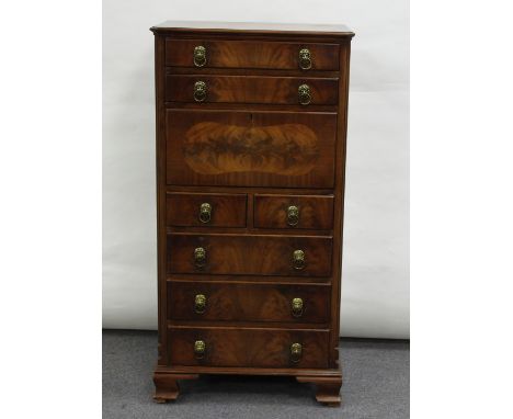 A mahogany chest with drawers and fall front, on ogee bracket feet, 60cm wide
