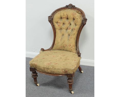 A Victorian button back nursing chair with walnut frame
