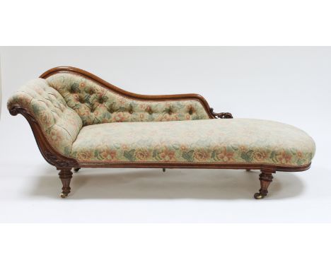 A Victorian walnut and button upholstered scroll end chaise longue, on turned legs with ceramic castors, 182.75cm long
