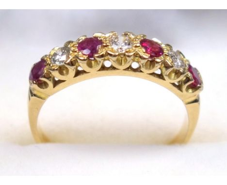 9 CT GOLD GARNET AND DIAMOND RING, SIZE Q 1/2, A SEVEN STONE SETTING (DIAMONDS APPROX. 3/16 TH CT.) GROSS WEIGHT 3.3 GRAMS 