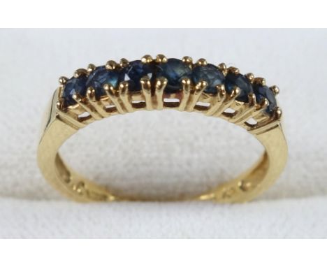 YELLOW METAL AND SAPPHIRE RING STAMPED 18 KT AND 750, SIZE N 1/2, SET SEVEN SAPPHIRES, GROSS WEIGHT 2.5 GRAMS 