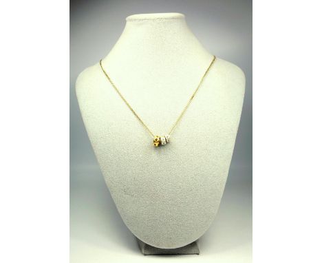 YELLOW METAL NECKLACE STAMPED 585 WITH A DIAMOND STUDDED AND HEART SHAPED PIERCED RING, TWO WHITE METAL AND DIAMOND 'HEX NUT'