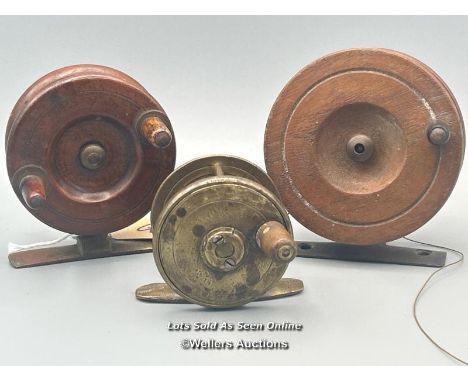 Two vintage oak reels with brass feet, largest 7.5cm diameter with a small brass reel 5cm diameter, all unbranded.
