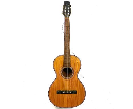 An early 20th century parlor guitar. With mother of pearl fretboard and bridge pin inlays, includes a soft case.The action at