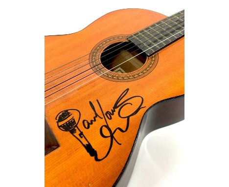 Signed PAUL Young, with a Cornwall Coliseum concert poster.  A signed Eros six string guitar, length 99cm, and a poster from 