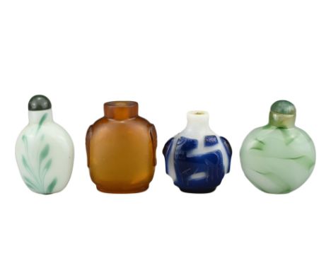 FOUR CHINESE SNUFF BOTTLES. Comprising an amber-coloured glass bottle with two mask and ring handles; a blue-overlay white gl