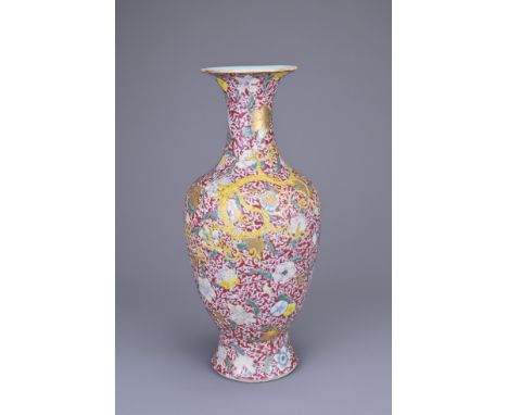 A CHINESE RUBY-GROUND FAMILLE ROSE ENAMELLED CHILONG VASE. Finely potted, decorated with yellow and blue chilong on continuou