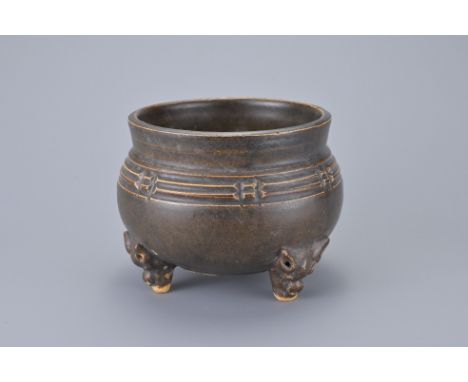 A CHINESE CIZHOU BROWN GLAZED TRIPOD CENSER, 12/13TH CENTURY. With banded decoration on three animal form feet. 12cm wide x 9