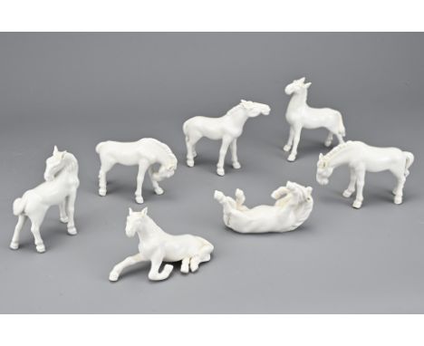 A GROUP OF SEVEN VINTAGE WHITE GLAZED PORCELAIN HORSES. In various poses. 8-9cm length. (7) 