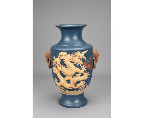 A CHINESE YIXING POTTERY VASE, 20TH CENTURY. Blue ground with animal form ring handles, decorated with raised decoration of d