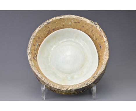 A FINE CHINESE SONG DYNASTY QINGBAI PORCELAIN DISH IN KILN SAGGAR. The kiln saggar containing a fine quality porcelain dish c