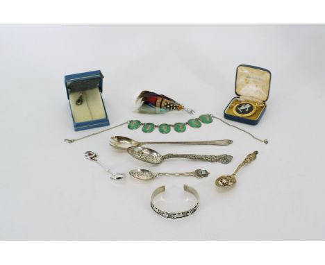 A large quantity of of silver souvenir spoons, a silver pickle fork, a Wedgwood pendent, a Siamese enamel and silver bracelet