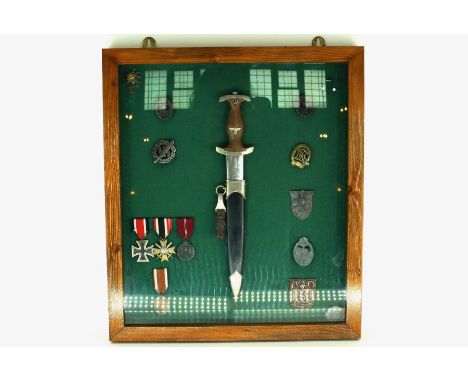 A nazi dagger, eight German badges, a set of German medals and another in a glazed case