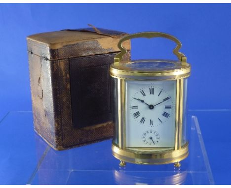 An early 20thC French gilt brass carriage clock with alarm, of 5-glass oval form, the white enamel dial with black Roman nume