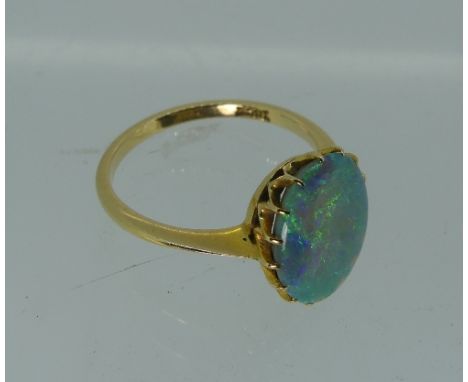 An opal RIng, the oval stone mounted in 18ct yellow gold, approx 13mm x 10mm, Size O½.