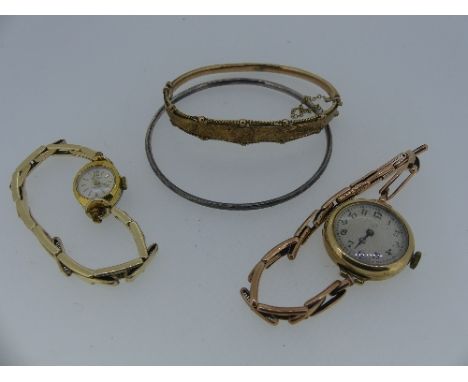 A 9ct yellow gold hollow hinged Bangle, the front foliate engraved and with a ropework border, 8.3g, together with a 9ct gold