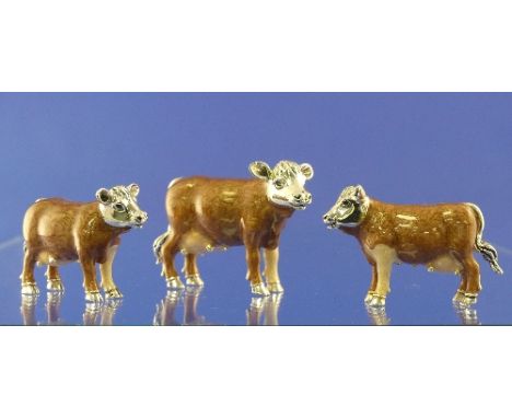 A set of three Saturno contemporary sterling silver and enamel brown Cows, largest 6.7cm long, two smaller 5.2cm long, full E