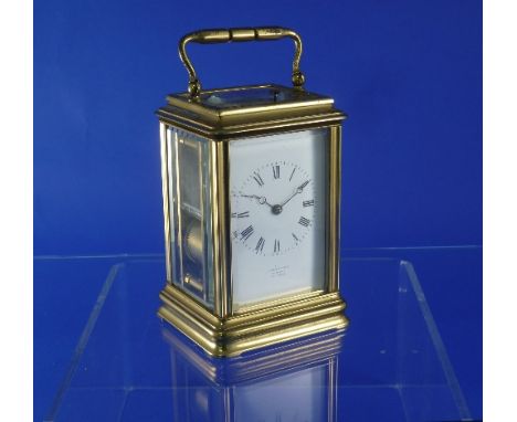 A French gilt brass striking carriage clock with repeat, of traditional five-glass form, the white dial signed "Fabrique de P
