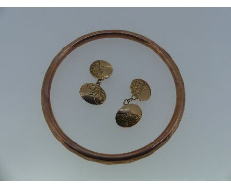 A pair of 9ct rose gold oval Cufflinks, each front diagonally half engraved with foliage and plain the other, chains between,