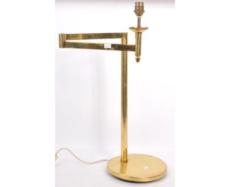 A vintage 1970's Hollywood Regency / Italian swing arm articulated brass lamp / light having a single column support raised o