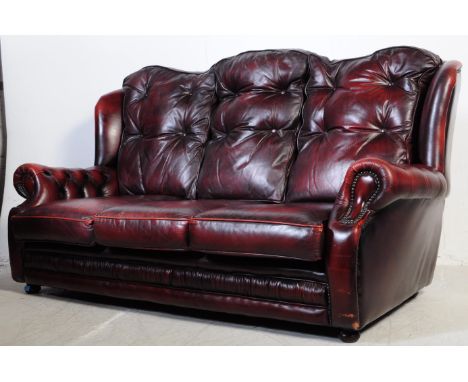 A vintage 20th century button back chesterfield three seater sofa settee couch. In oxblood colour with drop in button back cu