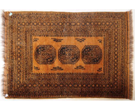 A vintage 20th century Persian Islamic middle eastern Afghan carpet floor rug. In a brown ground, with repeating central meda