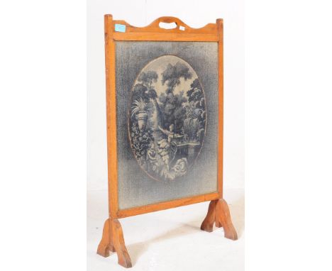 A vintage 20th century fire screen oak guard. Having carry handle to top with needle work decoration of a waterfall scene wit