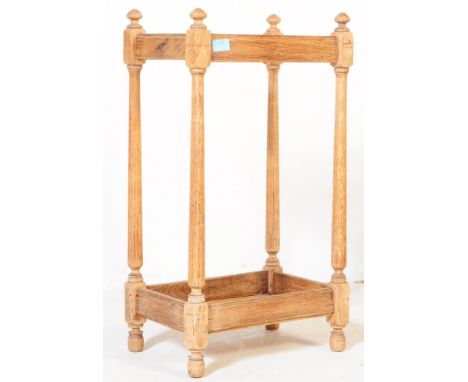 A Victorian oak umbrella stick stand. The stand having arrowhead finials over pillar type supports with undertray beneath. Me