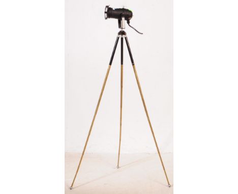 A retro 20th century brass &amp; chrome extendable tripod on ball feet, with a SkyTech 151.771 theatre light mounted upon it.