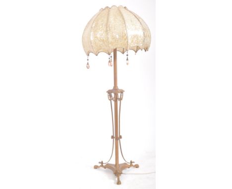 A 20th century French style metal gilt painted floor standing lamp with lucite shade. The standard lamp having three light bu