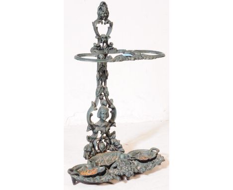 A 19th century Victorian Coalbrookdale painted green cast iron umbrella stick stand having hand to top with trefoil tray to b