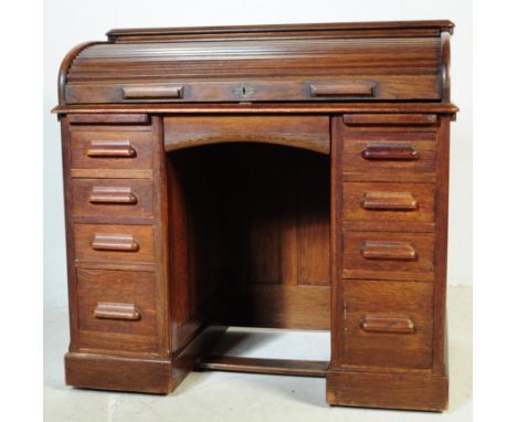 A 19th Century Victorian Lebus manner oak clerk's roll top desk, the tambour front opening to reveal drawers and recesses, ab