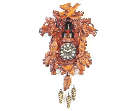 A large contemporary German Black Forest style Kaiser Quartz cuckoo clock. Battery operated with three pine cone 'weights' an